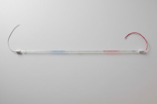 A long, thin transparent LED light strip with white connector ends, one of which has a looped red wire attached, photographed against a solid black background.